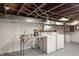 Unfinished basement with washer and dryer hookups, and a work table at 859 E Bunkerhill Rd, Mooresville, IN 46158