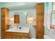 Well-lit bathroom featuring a vanity, mirrored cabinet, wooden shelving and an updated toilet at 859 E Bunkerhill Rd, Mooresville, IN 46158