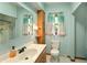 Bright bathroom featuring a large mirror, a wooden cabinet, and a toilet at 859 E Bunkerhill Rd, Mooresville, IN 46158
