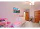 Cozy bedroom featuring gray carpet, a ceiling fan, and a mounted television on the lilac painted wall at 859 E Bunkerhill Rd, Mooresville, IN 46158