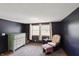 This bedroom features large windows allowing ample natural light and a chest of drawers at 859 E Bunkerhill Rd, Mooresville, IN 46158