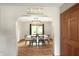 Elegant dining room with a stylish light fixture, table setting, and doorway view at 859 E Bunkerhill Rd, Mooresville, IN 46158