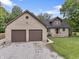 This home features a large two car garage and a brick exterior with a well-maintained lawn at 859 E Bunkerhill Rd, Mooresville, IN 46158