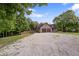 This home features a long driveway, large yard, and mature trees at 859 E Bunkerhill Rd, Mooresville, IN 46158