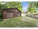 A spacious two-car garage with a wide driveway, surrounded by lush greenery at 859 E Bunkerhill Rd, Mooresville, IN 46158