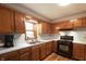 Charming kitchen featuring wood cabinets, gas range, and a window over the sink at 859 E Bunkerhill Rd, Mooresville, IN 46158