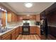 Functional kitchen with wooden cabinetry and modern appliances, perfect for cooking at 859 E Bunkerhill Rd, Mooresville, IN 46158