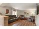 Comfortable living room with leather seating, a decorative wood map, and bright windows at 859 E Bunkerhill Rd, Mooresville, IN 46158