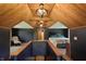 Spacious main bedroom featuring a wood-clad vaulted ceiling, unique chandelier and a cozy sitting area at 859 E Bunkerhill Rd, Mooresville, IN 46158