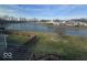 Beautiful backyard view with a pond, a fire pit and a wooden fence at 10915 Mansfield Way, Ingalls, IN 46048