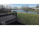 Scenic backyard featuring a pond and a wooden deck overlooking the landscape at 10915 Mansfield Way, Ingalls, IN 46048