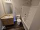 Bathroom featuring vanity with sink, toilet and tub/shower combo with white tile surround at 10915 Mansfield Way, Ingalls, IN 46048
