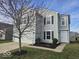 Charming two-story home with gray siding, black shutters, and a well-maintained front yard at 10915 Mansfield Way, Ingalls, IN 46048