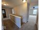 Upstairs hallway with access to bathroom and bedroom, featuring neutral walls and carpeted floor at 10915 Mansfield Way, Ingalls, IN 46048