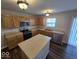 The kitchen is equipped with stainless steel appliances, wooden cabinets and an island at 10915 Mansfield Way, Ingalls, IN 46048