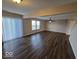 Spacious living area with dark vinyl floors and lots of natural light at 10915 Mansfield Way, Ingalls, IN 46048