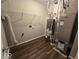 Bright utility room with overhead shelving and modern appliances, featuring wood look floor at 10915 Mansfield Way, Ingalls, IN 46048