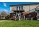 Exterior view of the brick facade and second story balconies overlooking the yard at 11931 E Welland St, Indianapolis, IN 46229