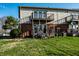 Exterior view of a townhome with balconies overlooking the green backyard at 11931 E Welland St, Indianapolis, IN 46229