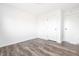 This bedroom has wood-look floors, two doors, and neutral walls at 11931 E Welland St, Indianapolis, IN 46229
