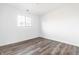 Bright bedroom featuring wood-look flooring and a window for ample natural light at 11931 E Welland St, Indianapolis, IN 46229