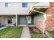 Two-story townhouse featuring classic siding, brick accents, and walkway to entry door at 11931 E Welland St, Indianapolis, IN 46229