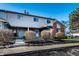 Two-story townhouse featuring classic siding, brick accents, and lush landscaping at 11931 E Welland St, Indianapolis, IN 46229