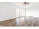 Naturally lit living room with new flooring and patio access, perfect for relaxation at 11931 E Welland St, Indianapolis, IN 46229