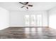 Spacious living room features new flooring, modern ceiling fan, and bright natural light at 11931 E Welland St, Indianapolis, IN 46229