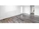 Living Room featuring hard surface floors, neutral walls and access to the kitchen and exterior at 11931 E Welland St, Indianapolis, IN 46229