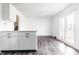 Open living area with new flooring, white walls, and doors to the outdoor deck at 11931 E Welland St, Indianapolis, IN 46229