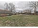 An expansive backyard featuring a shed, wooden fence, covered patio, and grassy area for outdoor enjoyment at 1231 S Pershing Ave, Indianapolis, IN 46221