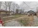 The backyard includes a covered patio, a grassy area, a shed, and a wooden fence with a gravel perimeter at 1231 S Pershing Ave, Indianapolis, IN 46221