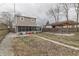 The backyard features a covered patio and a spacious lawn area, enclosed by a wooden fence at 1231 S Pershing Ave, Indianapolis, IN 46221