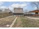 The backyard has a covered patio area, a pathway, and a large grassy area surrounded by a wooden fence at 1231 S Pershing Ave, Indianapolis, IN 46221