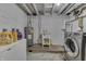 Unfinished basement with laundry hookups and water heater at 1231 S Pershing Ave, Indianapolis, IN 46221