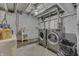 Unfinished basement featuring laundry appliances and utility sink at 1231 S Pershing Ave, Indianapolis, IN 46221