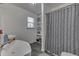 Bright bathroom with dual sinks, built-in shelves, and a stylish patterned shower curtain at 1231 S Pershing Ave, Indianapolis, IN 46221