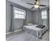 Cozy bedroom featuring neutral walls, ceiling fan, and windows offering natural light at 1231 S Pershing Ave, Indianapolis, IN 46221