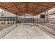 The covered carport area has a concrete slab base and is surrounded by gravel and a wooden fence at 1231 S Pershing Ave, Indianapolis, IN 46221