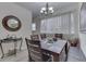 Bright dining room featuring a dark wood table, modern lighting, and a large window for ample natural light at 1231 S Pershing Ave, Indianapolis, IN 46221