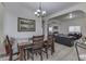 Inviting dining room featuring a dark wood table, modern light fixture, and an open layout connecting to living room at 1231 S Pershing Ave, Indianapolis, IN 46221