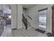 Bright entryway with light gray flooring and wooden staircase leading to upper levels at 1231 S Pershing Ave, Indianapolis, IN 46221
