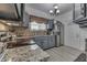 Well-lit kitchen with gray cabinets, stainless appliances, and granite countertops at 1231 S Pershing Ave, Indianapolis, IN 46221