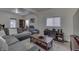 Spacious living room with a large grey sectional sofa, wood accents, and ample natural light at 1231 S Pershing Ave, Indianapolis, IN 46221