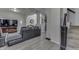 Bright living room features modern gray sectional, light gray flooring and open layout at 1231 S Pershing Ave, Indianapolis, IN 46221