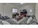 Comfortable living room with a large grey sectional sofa, wood coffee table, and modern entertainment center at 1231 S Pershing Ave, Indianapolis, IN 46221