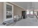 A covered patio with an exterior door, refrigerator, and a small table with neutral tones at 1231 S Pershing Ave, Indianapolis, IN 46221
