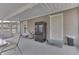 Covered patio shows back entrance, refrigerator, table and chairs in a neutral setting with outdoor access at 1231 S Pershing Ave, Indianapolis, IN 46221