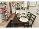 Open dining area with wood-style floors, dark table with seating for four, and stylish decor, perfect for Gathering meals at 15524 Dusty Trl, Noblesville, IN 46060